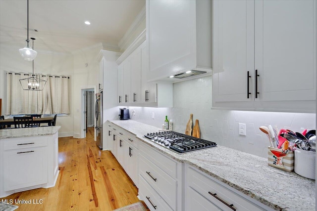 1622 Old Lake Rd, Brandon, MS 39042 - kitchen with appliances with stainless steel finishes, tasteful backsplash, custom exhaust hood, white cabinets, and pendant lighting