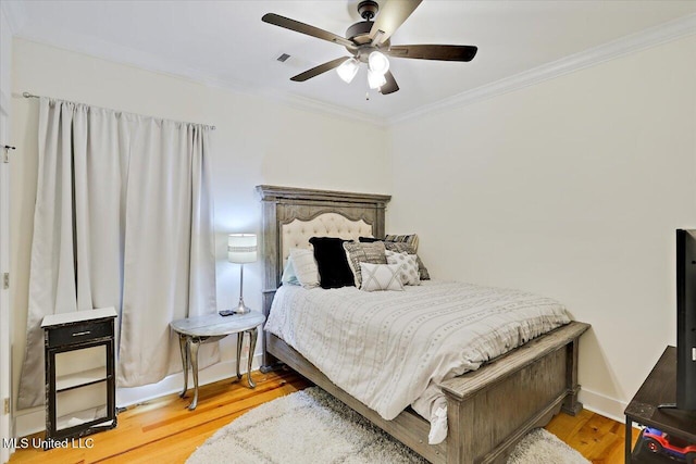 1622 Old Lake Rd, Brandon, MS 39042 - bedroom with crown molding, wood finished floors, a ceiling fan, and baseboards