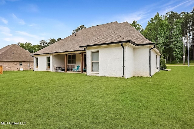 1622 Old Lake Rd, Brandon, MS 39042 - rear view of house with a lawn, a patio, and a shingled roof