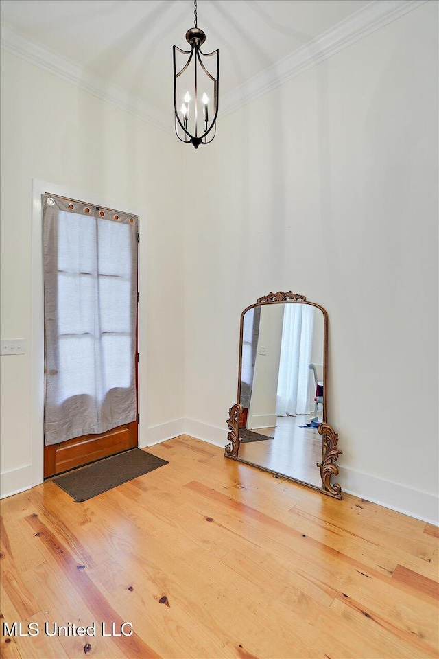 1622 Old Lake Rd, Brandon, MS 39042 - spare room featuring a chandelier, wood finished floors, ornamental molding, and baseboards