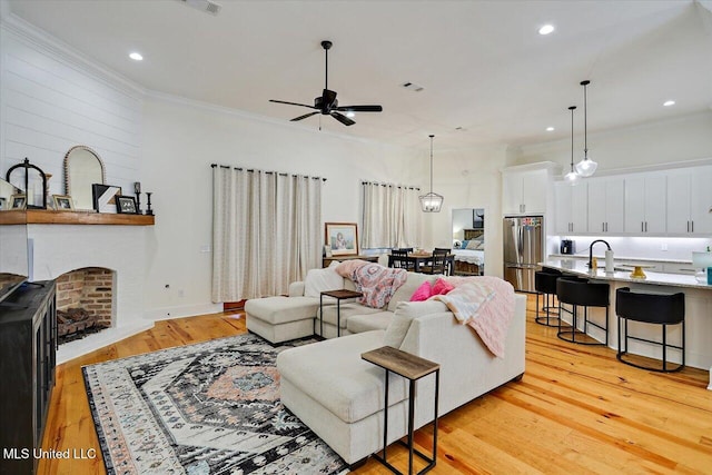 1622 Old Lake Rd, Brandon, MS 39042 - living room featuring ceiling fan, light wood-type flooring, recessed lighting, crown molding, and a fireplace