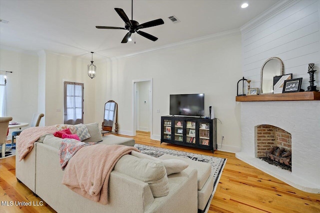 1622 Old Lake Rd, Brandon, MS 39042 - living room with ornamental molding, wood finished floors, ceiling fan, a brick fireplace, and recessed lighting
