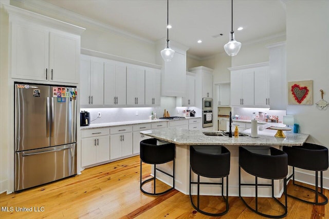 1622 Old Lake Rd, Brandon, MS 39042 - kitchen featuring appliances with stainless steel finishes, ornamental molding, a breakfast bar, a sink, and backsplash