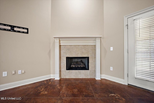 unfurnished living room with a tiled fireplace