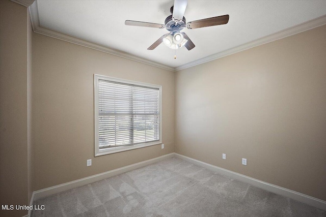 carpeted empty room featuring crown molding and ceiling fan