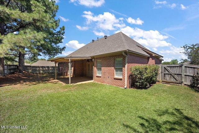 back of property featuring a patio and a yard