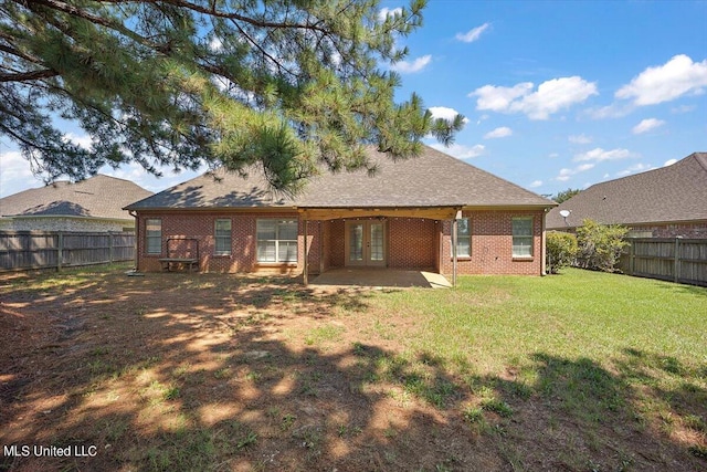 back of property featuring a patio and a lawn