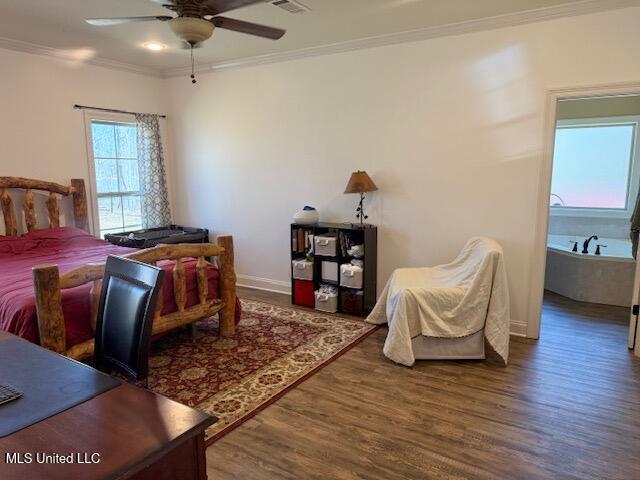 bedroom featuring baseboards, ornamental molding, ceiling fan, and wood finished floors