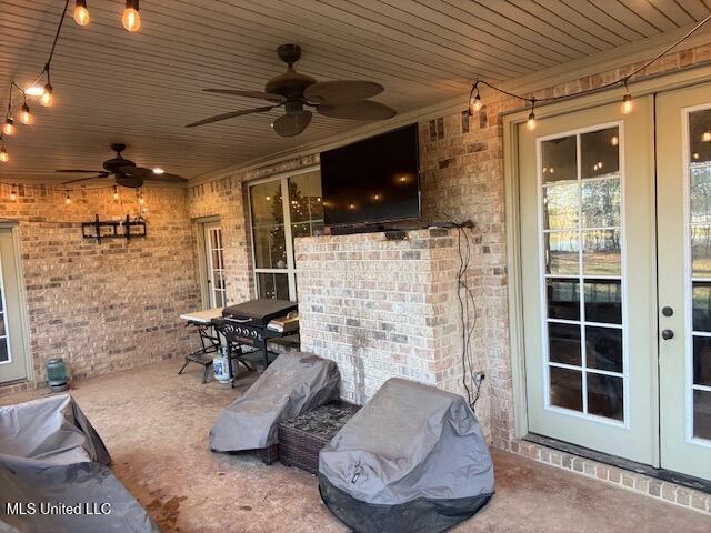 view of patio with french doors, outdoor dining space, and a ceiling fan