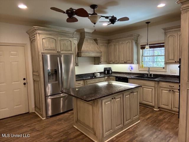 kitchen featuring dark wood finished floors, ornamental molding, black appliances, premium range hood, and a sink