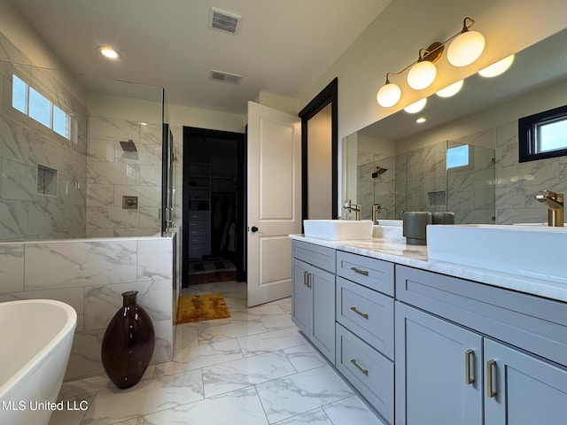 full bath with a stall shower, marble look tiles, double vanity, a freestanding bath, and recessed lighting