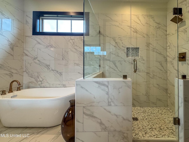 bathroom featuring a freestanding bath, a stall shower, and marble look tile flooring
