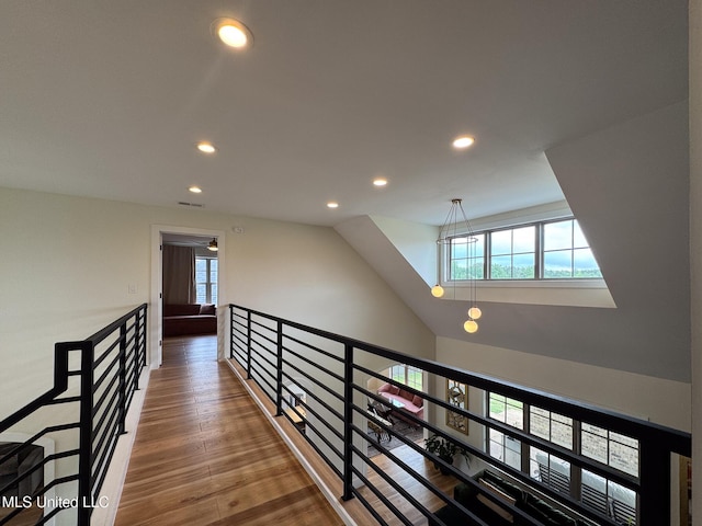 hallway with recessed lighting, plenty of natural light, and wood finished floors