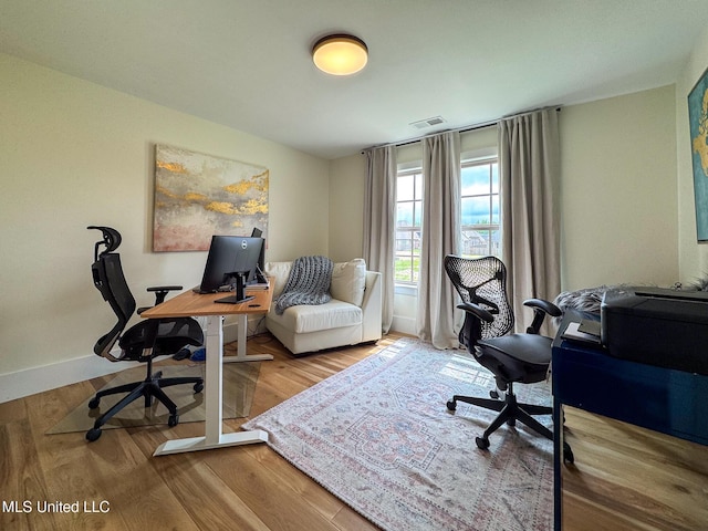 office featuring baseboards and wood finished floors