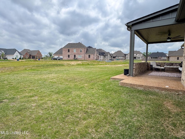 view of green lawn featuring a patio area, a residential view, an outdoor hangout area, and ceiling fan