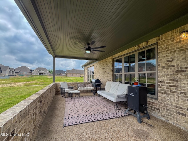 view of patio with a ceiling fan, an outdoor living space, and a residential view