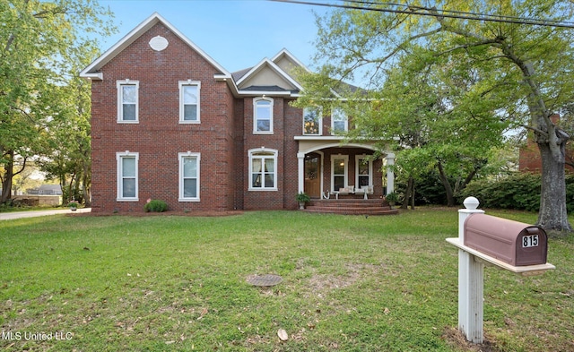 view of front of property with a front yard and covered porch