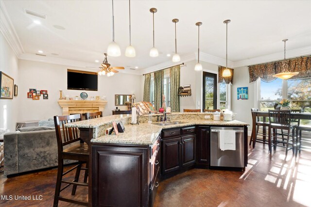 815 Warren St, Pascagoula, MS 39567 - kitchen with dishwasher, a sink, a ceiling fan, open floor plan, and a breakfast bar area