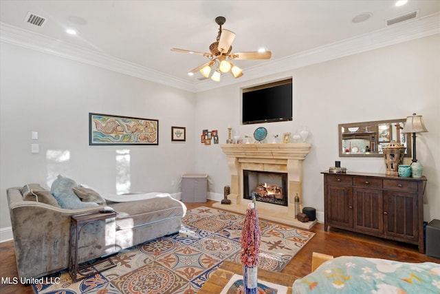 living room with crown molding, dark hardwood / wood-style flooring, and ceiling fan