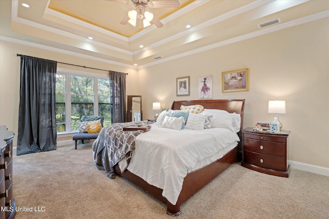 carpeted bedroom featuring ceiling fan, crown molding, and a tray ceiling