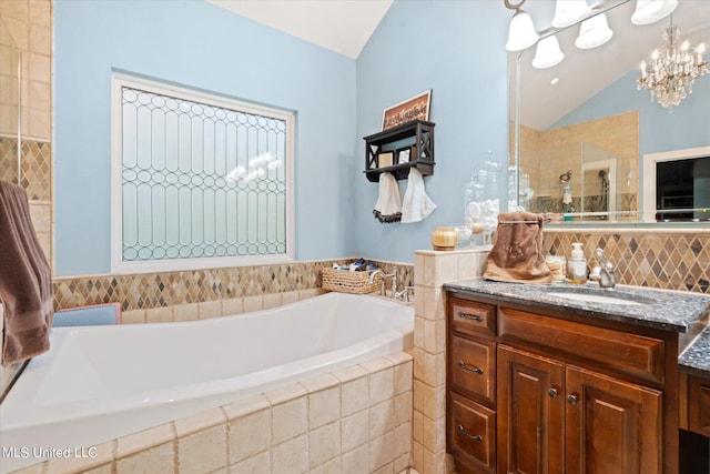 bathroom featuring vanity, vaulted ceiling, separate shower and tub, and an inviting chandelier