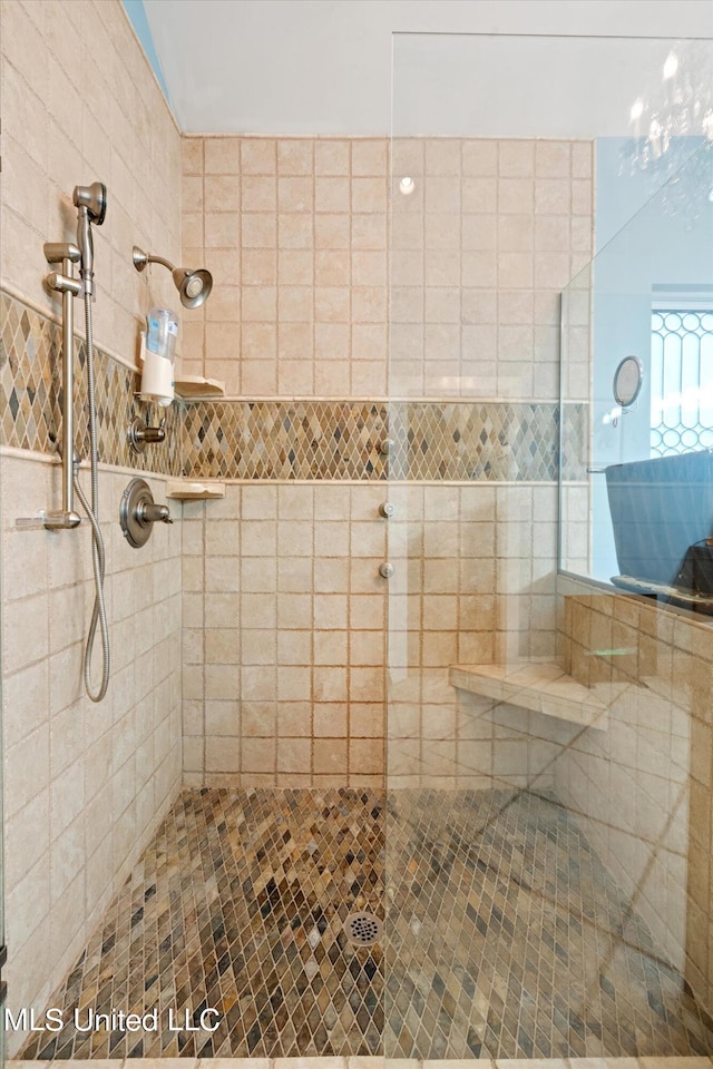 bathroom with tiled shower