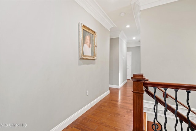 corridor featuring ornamental molding and hardwood / wood-style floors