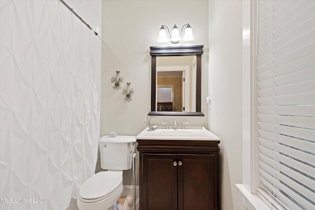 bathroom with vanity, toilet, and walk in shower