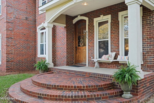 815 Warren St, Pascagoula, MS 39567 - view of exterior entry featuring brick siding and a porch