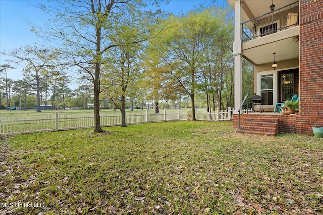 view of yard featuring a patio area and a balcony