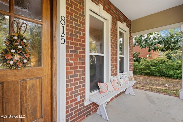 815 Warren St, Pascagoula, MS 39567 - doorway to property with brick siding and covered porch