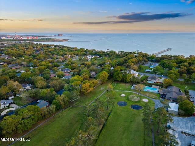 aerial view at dusk featuring a water view