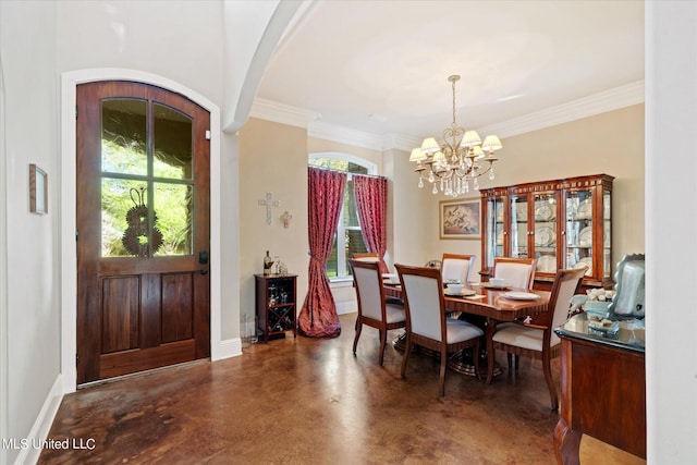 815 Warren St, Pascagoula, MS 39567 - dining area featuring arched walkways, finished concrete floors, a chandelier, baseboards, and ornamental molding