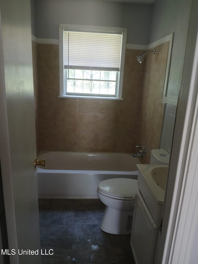 bathroom featuring toilet, shower / washtub combination, and vanity