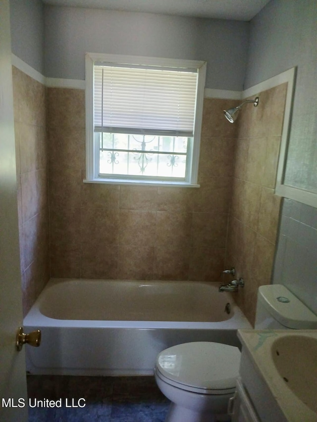 bathroom featuring vanity, bathing tub / shower combination, and toilet