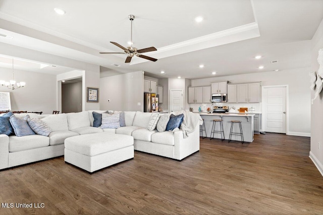 15380 Woodmanse Way, Diberville, MS 39540 - living room featuring recessed lighting, dark wood-style floors, a raised ceiling, a chandelier, and ceiling fan