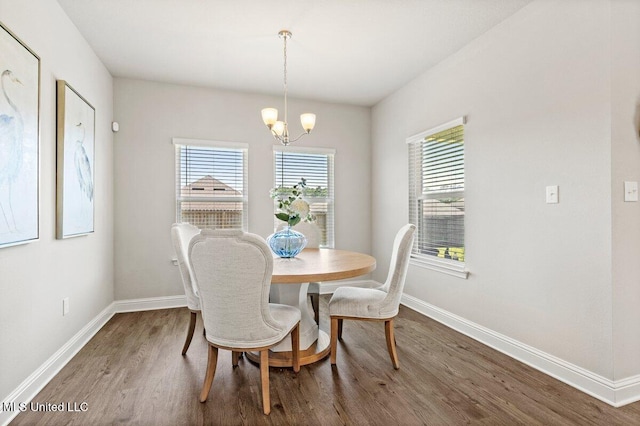 15380 Woodmanse Way, Diberville, MS 39540 - dining room with wood finished floors, a chandelier, and baseboards