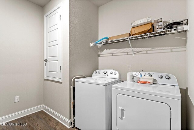 15380 Woodmanse Way, Diberville, MS 39540 - laundry room featuring washer and clothes dryer, dark wood finished floors, and baseboards