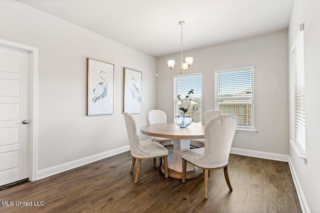 15380 Woodmanse Way, Diberville, MS 39540 - dining space featuring dark wood-style flooring, a chandelier, and baseboards