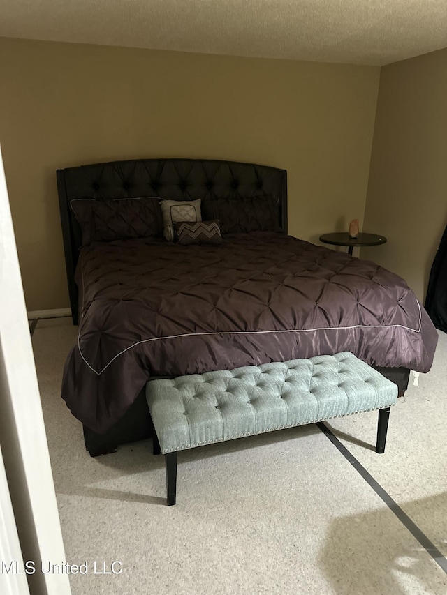 bedroom featuring a textured ceiling and carpet