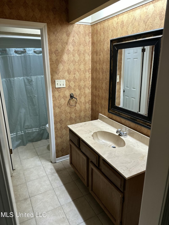 bathroom with vanity, a skylight, tile patterned floors, and toilet