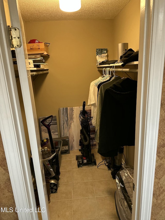 spacious closet featuring light tile patterned floors