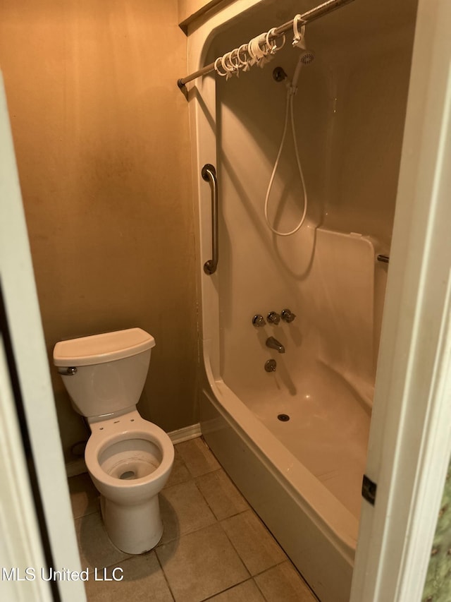 bathroom with tub / shower combination, tile patterned floors, and toilet