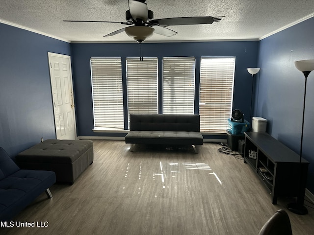 unfurnished living room with hardwood / wood-style flooring, crown molding, a healthy amount of sunlight, and a textured ceiling