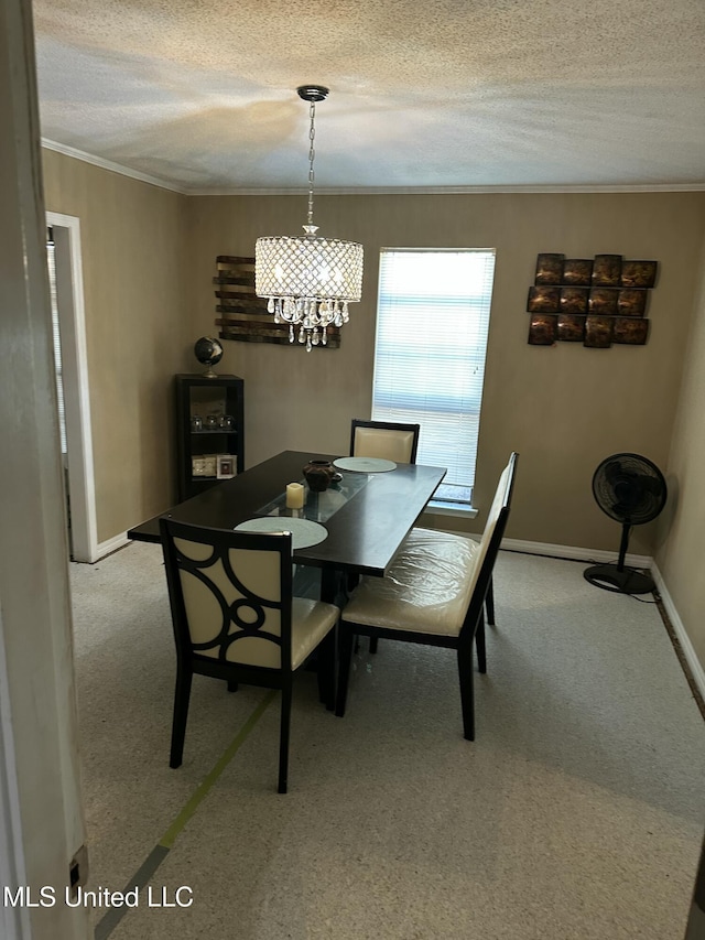 carpeted dining area featuring ornamental molding, a textured ceiling, and a notable chandelier