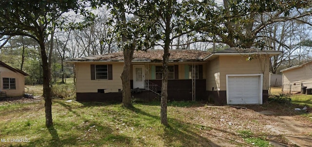 single story home featuring a front lawn and a garage