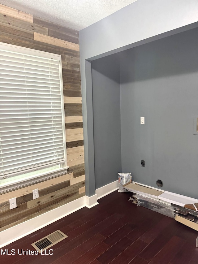 1708 Robinson St, Natchez, MS 39120 - washroom with visible vents, wood walls, and wood finished floors