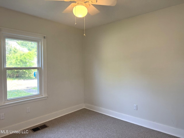 1708 Robinson St, Natchez, MS 39120 - spare room featuring dark carpet, a wealth of natural light, visible vents, and baseboards