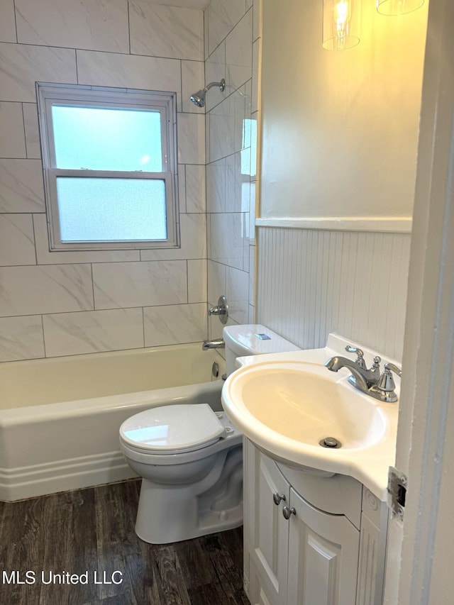 1708 Robinson St, Natchez, MS 39120 - full bath with vanity, toilet, a wainscoted wall, wood finished floors, and  shower combination