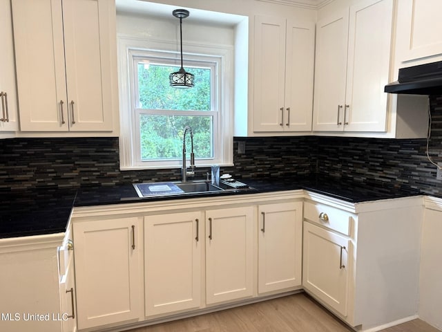 1708 Robinson St, Natchez, MS 39120 - kitchen with white cabinets, dark countertops, decorative backsplash, and a sink